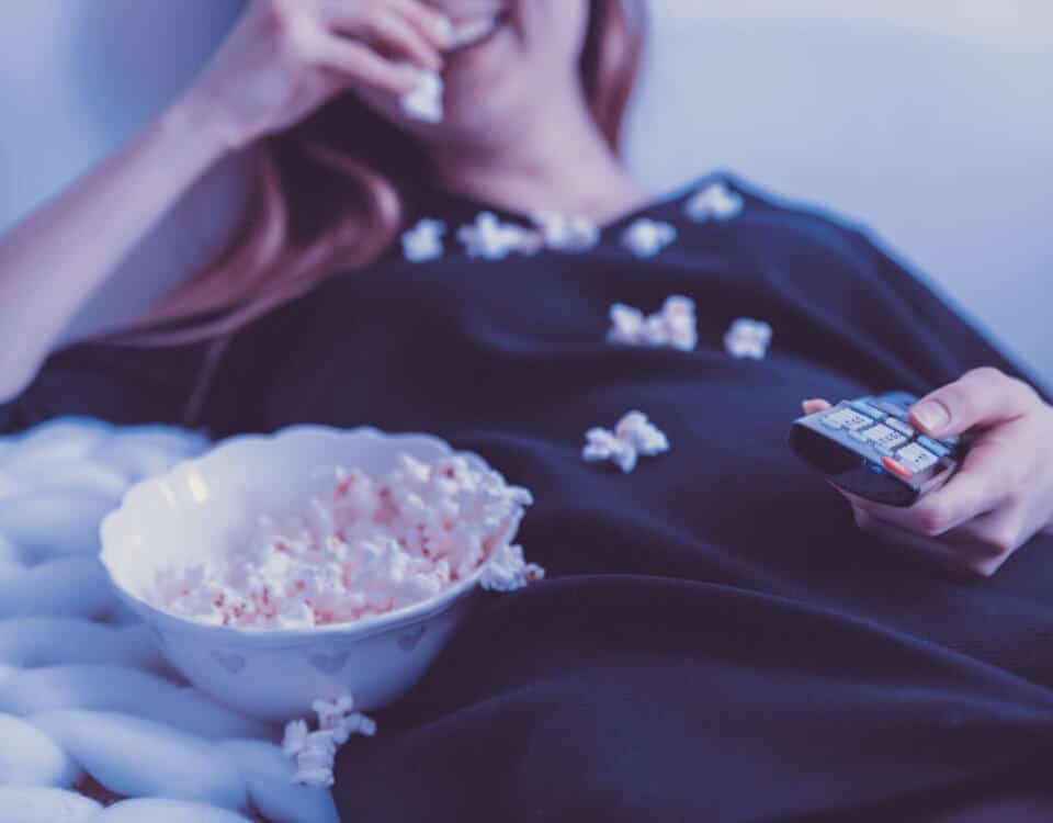woman-wearing-black-dress-shirt-eating-popcorn-1040159